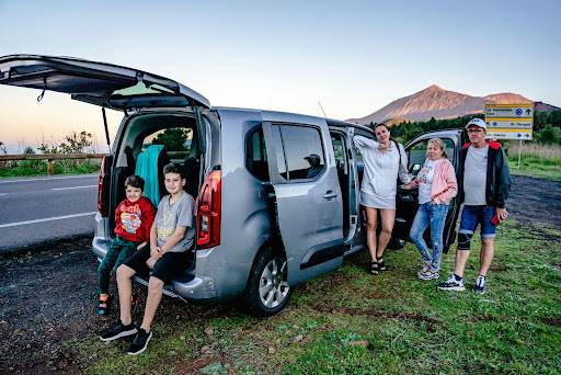 Family traveling in a passenger van for a multi-day road trip