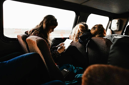 Passengers riding comfortably inside a 12 passenger van during a group trip