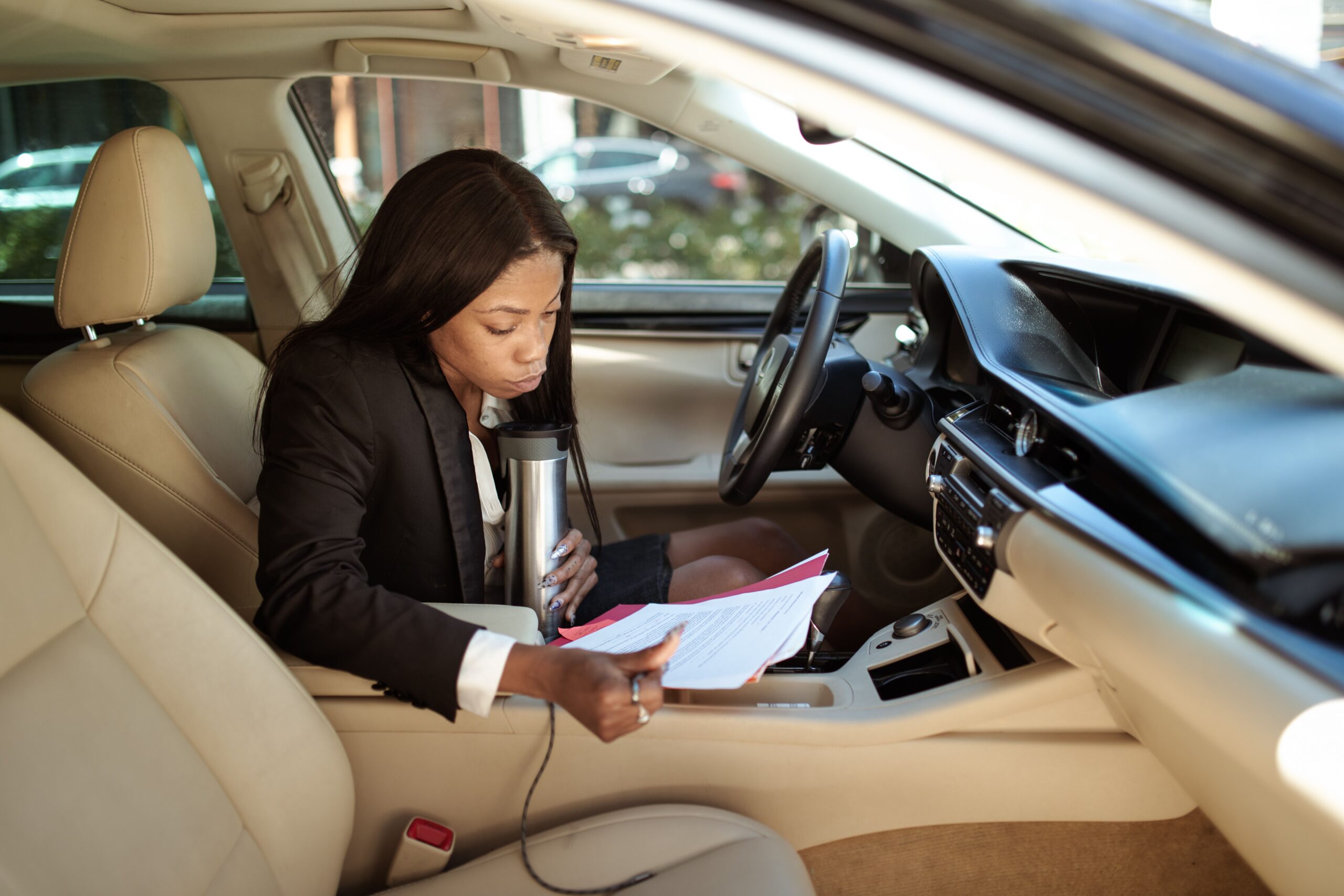 Customer reviewing rental car paperwork and vehicle agreement before pickup
