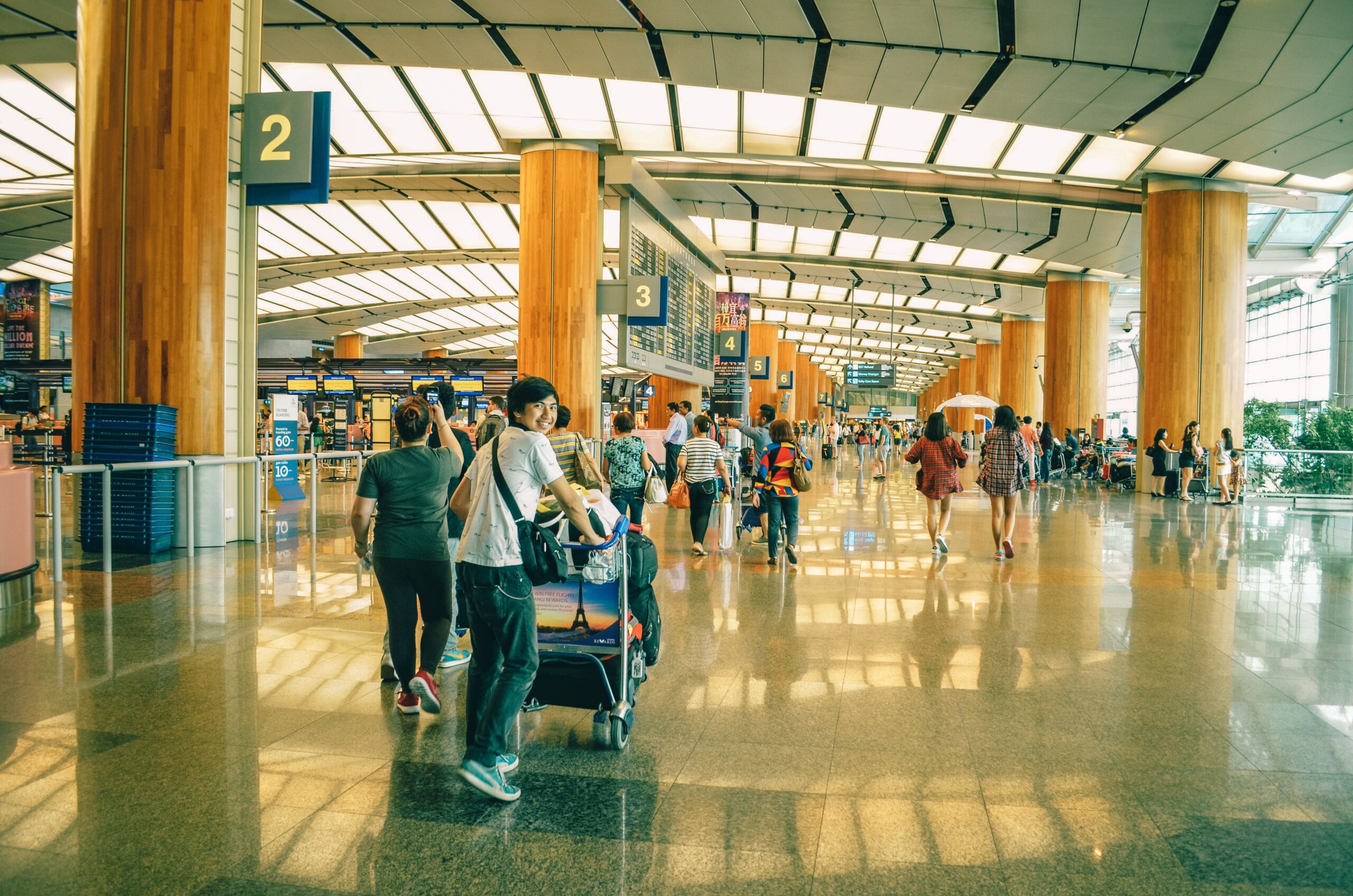 Family loading luggage into an SUV rental outside an airport terminal