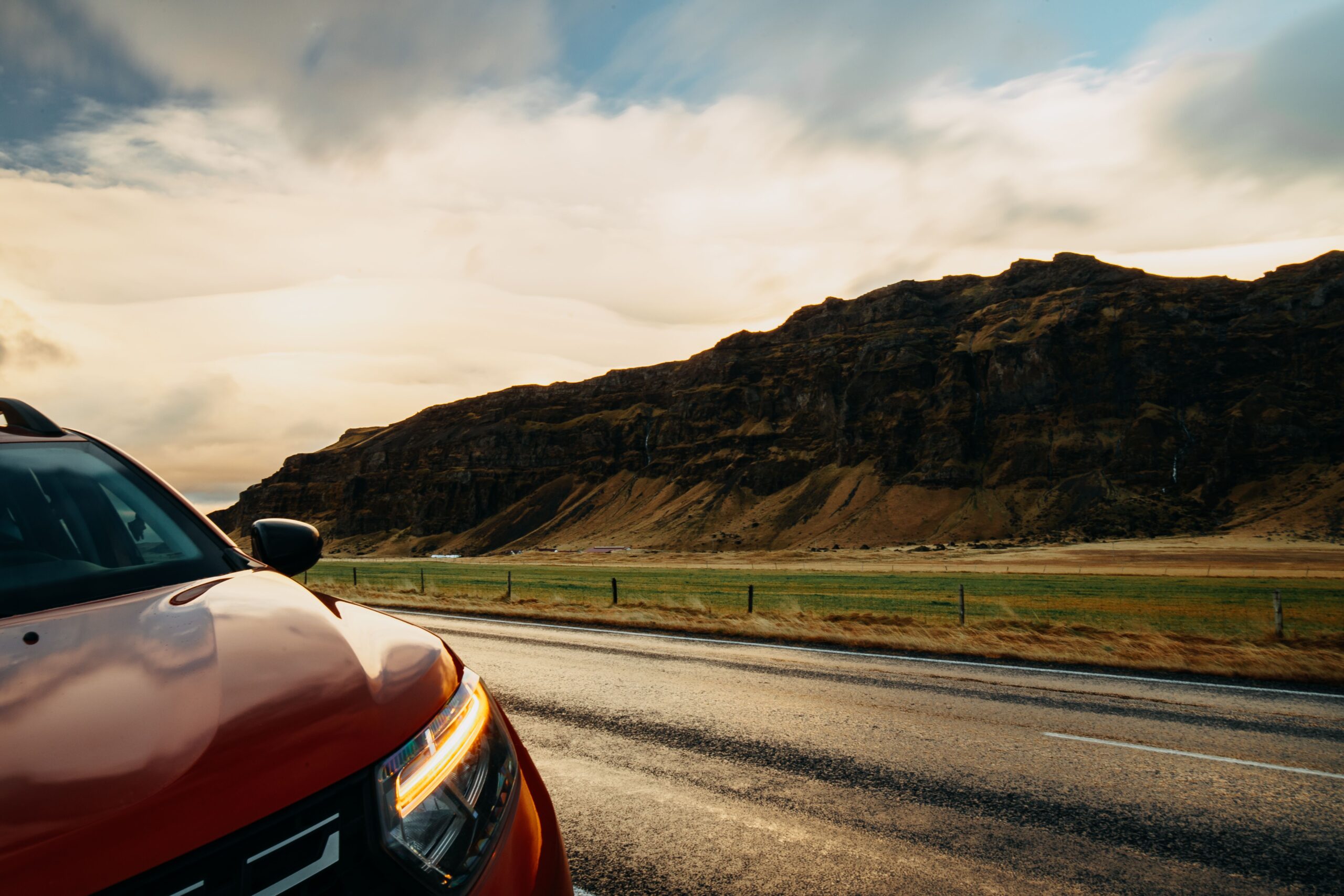 Rental car on an open road representing unlimited mileage and flexible travel plans