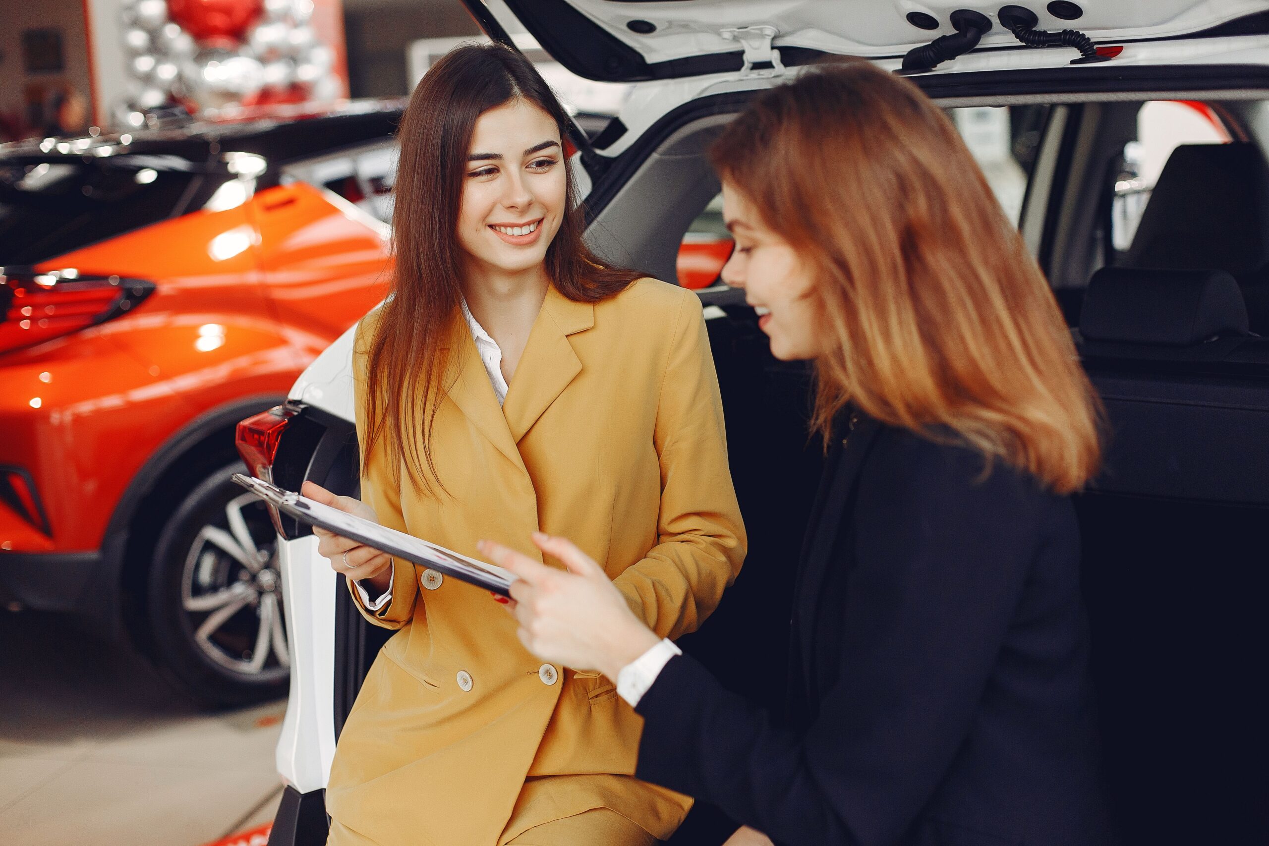 Customer reviewing a rental agreement with a rental agent at the counter