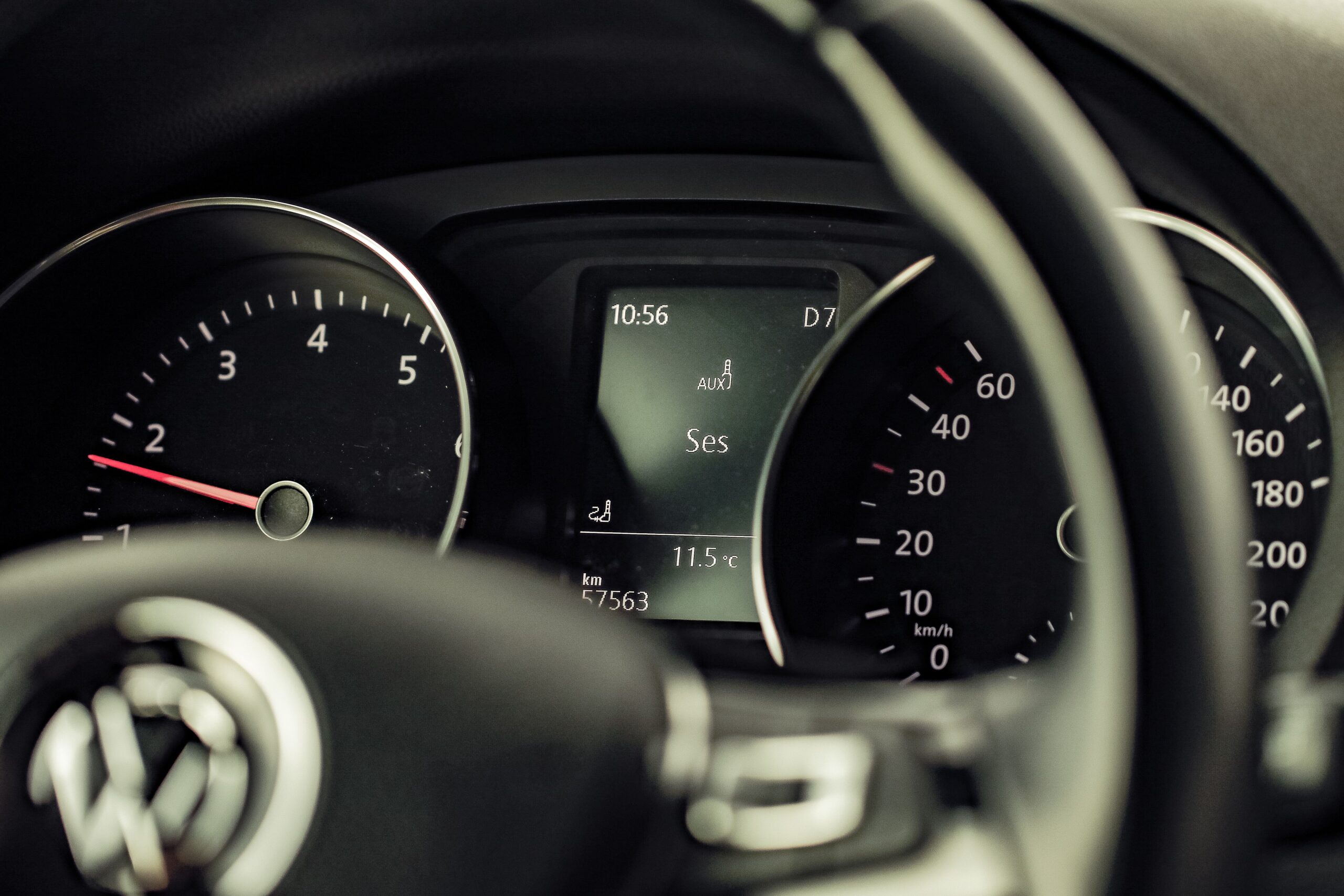 Close-up of a fuel gauge and dashboard inside a rental car