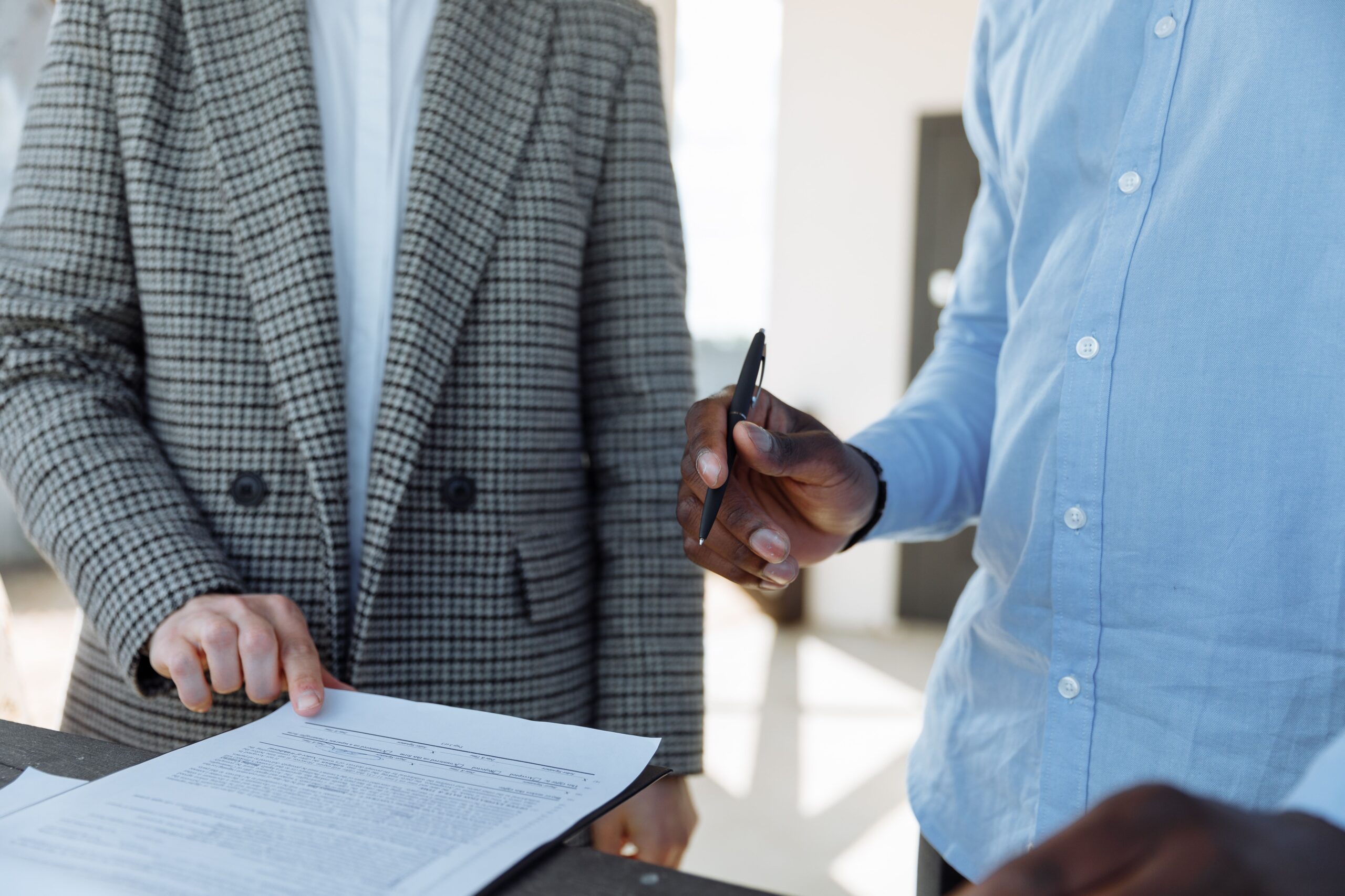 Traveler reviewing a rental agreement at a counter near Charleston International Airport